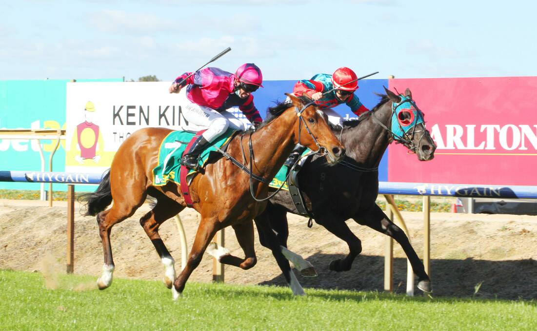 Hannah Edgley steers the Brent Stanley-trained Donndubhan (inside) to victory at Benalla on Monday. Picture: DAVID THORPE/RACING PHOTOS