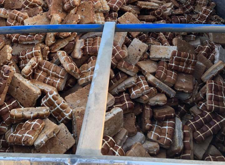 St Arnaud transport company Hendy Transport enlisted the help of St Arnaud Football Club to unpack 16 tonnes of hot cross buns. Pictures: CONTRIBUED