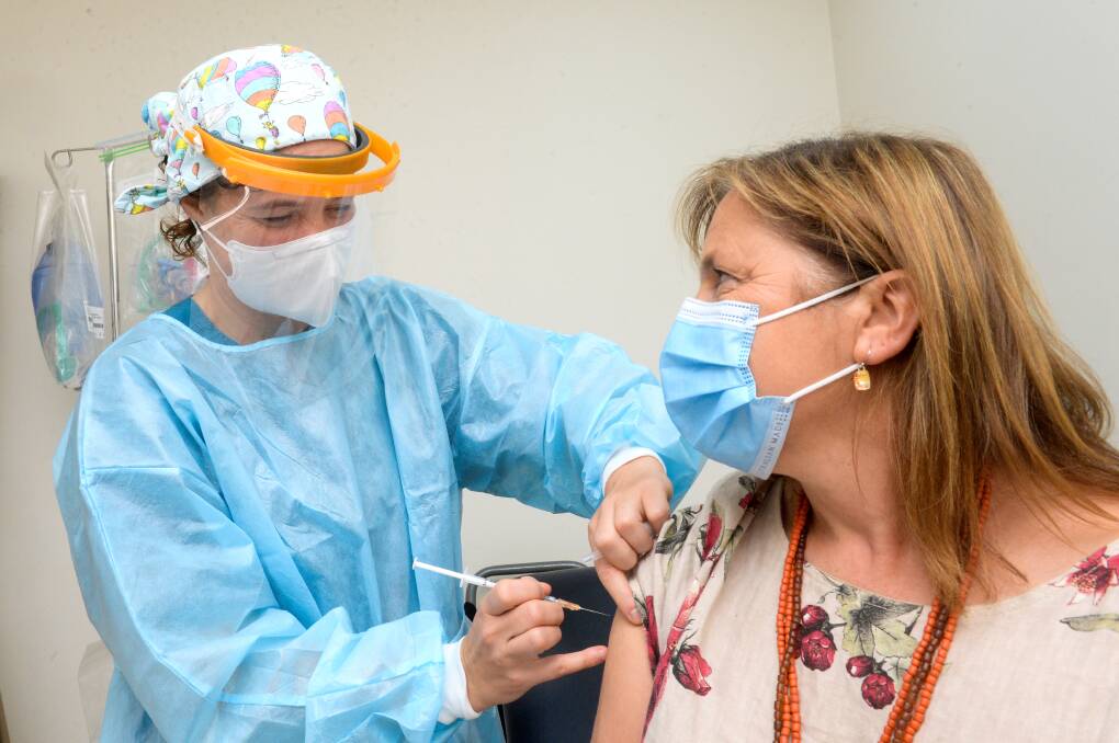 Dr Hannah Ward giving the coronavirus vaccine to Dr Ewa Piejko. Picture: DARREN HOWE