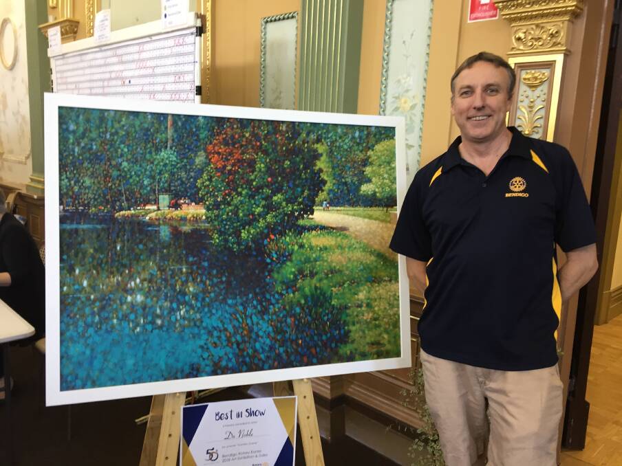 Rotary Club of Bendigo Easter art show coordinator Brian Figg with the winning artwork from the Easter art exhibition. 