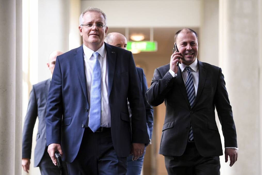 Prime Minister elect Scott Morrison and Deputy leader of the Liberal party Josh Frydenberg leave after a Liberal party room meeting at Parliament House in Canberra. Photo: AAP/Lukas Coch