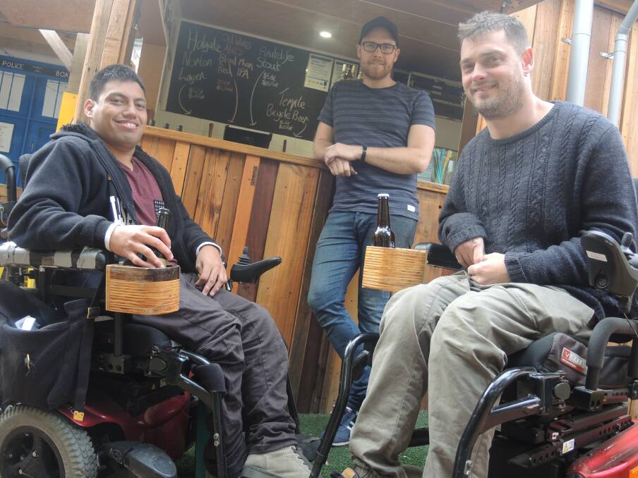 COLD ONES: Tamati Poingdestre, Jesse Gollan and Jye Yates kick back with beers at Handle Bar, which has modified its layout to support patrons with disabilities.
