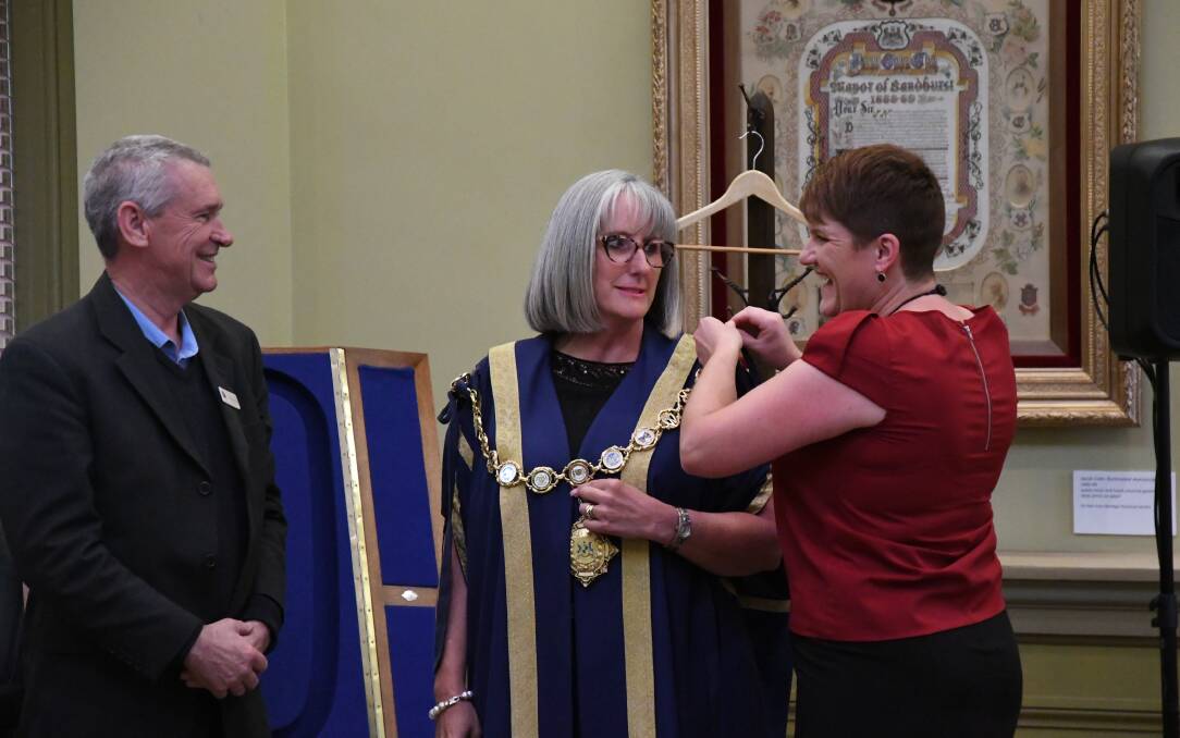 Mayor Margaret O'Rourke receives the mayoral robes with councillors George Flack and Yvonne Wrigglesworth. Picture: ADAM HOLMES
