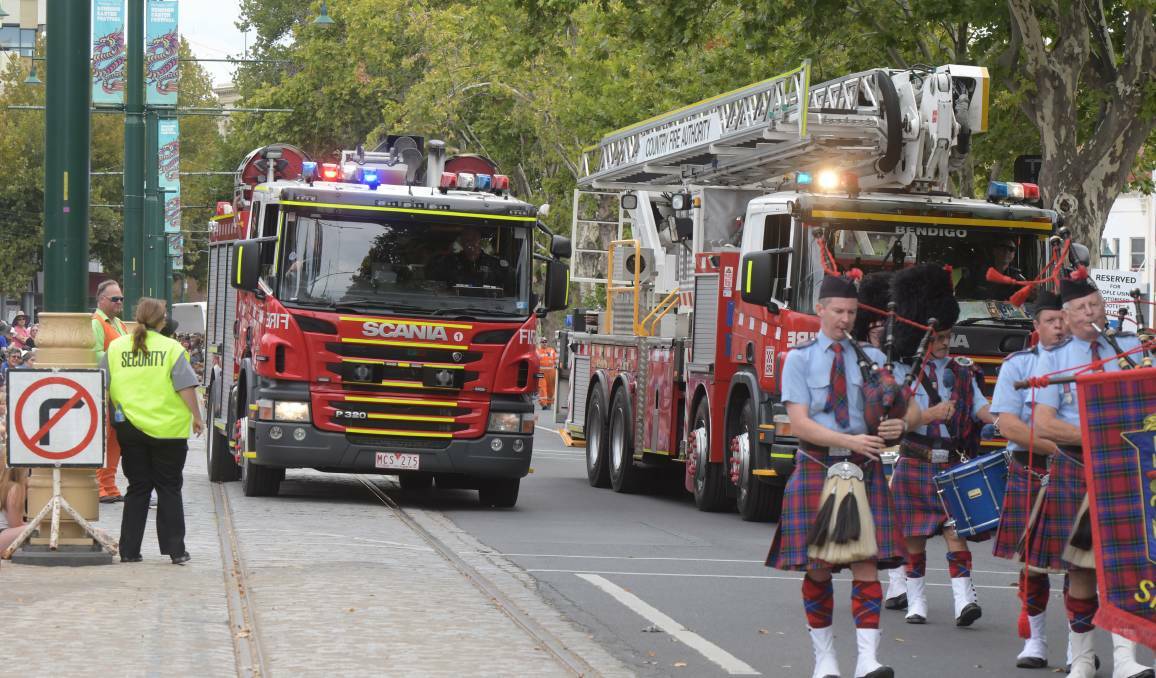 A fire truck attempts to exit the Easter Gala Parade last month after being called to a structure fire in Long Gully. Picture: NONI HYETT