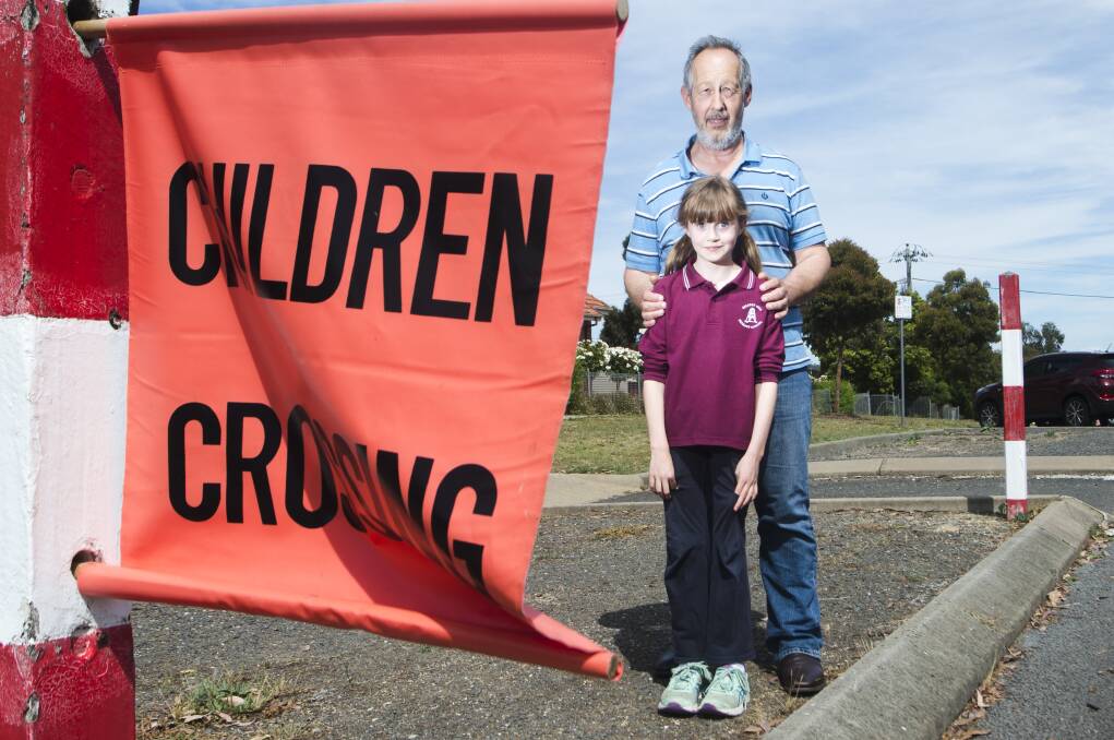 Quarry Hill Primary School parent Tony Smith and his daughter Emma at the Peel Street crossing, which is no longer supervised. Picture: DARREN HOWE