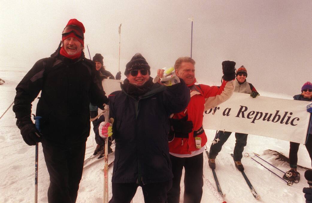 SUPPORT: Tom Keneally (centre) with Bryan Brown and Billy Thorpe, unfurling a Vote Republic banner on Mount Kosciuszko.
