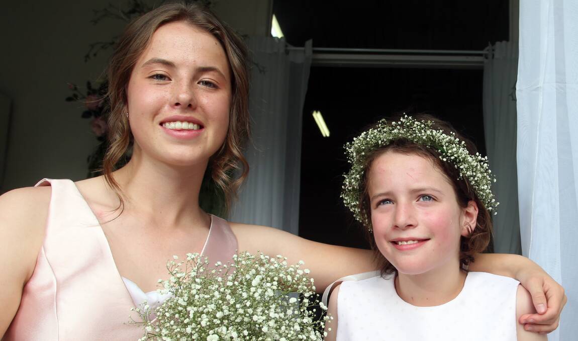 FLOWER GIRLS: Sophie and Jacqui Butcher were invited to join the wedding ceremony. The newlyweds asked guests to donate to KCNQ2 Cure, which will help find a cure for sufferers like Jacqui. Picture: GLENN DANIELS