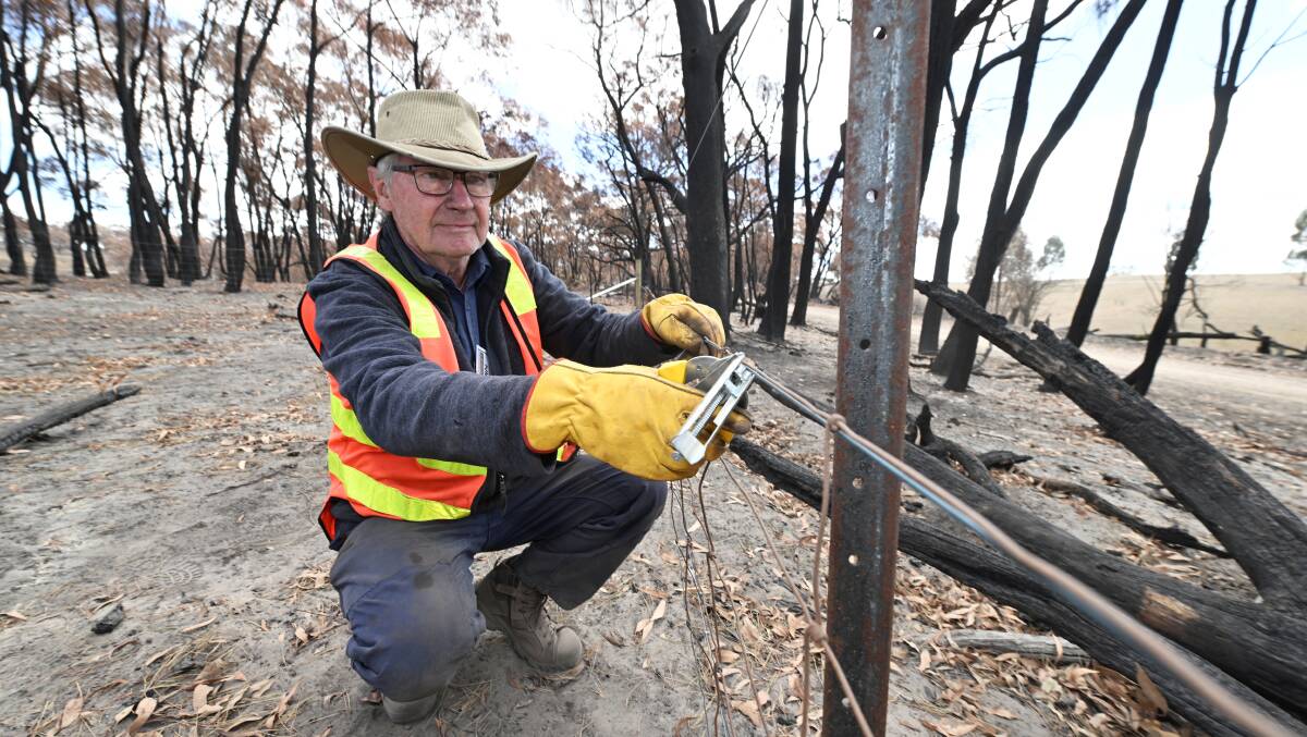 Blaze Aid volunteer John Banks helps rebuild fences on a property near Raglan. Picture by Lachlan Bence
