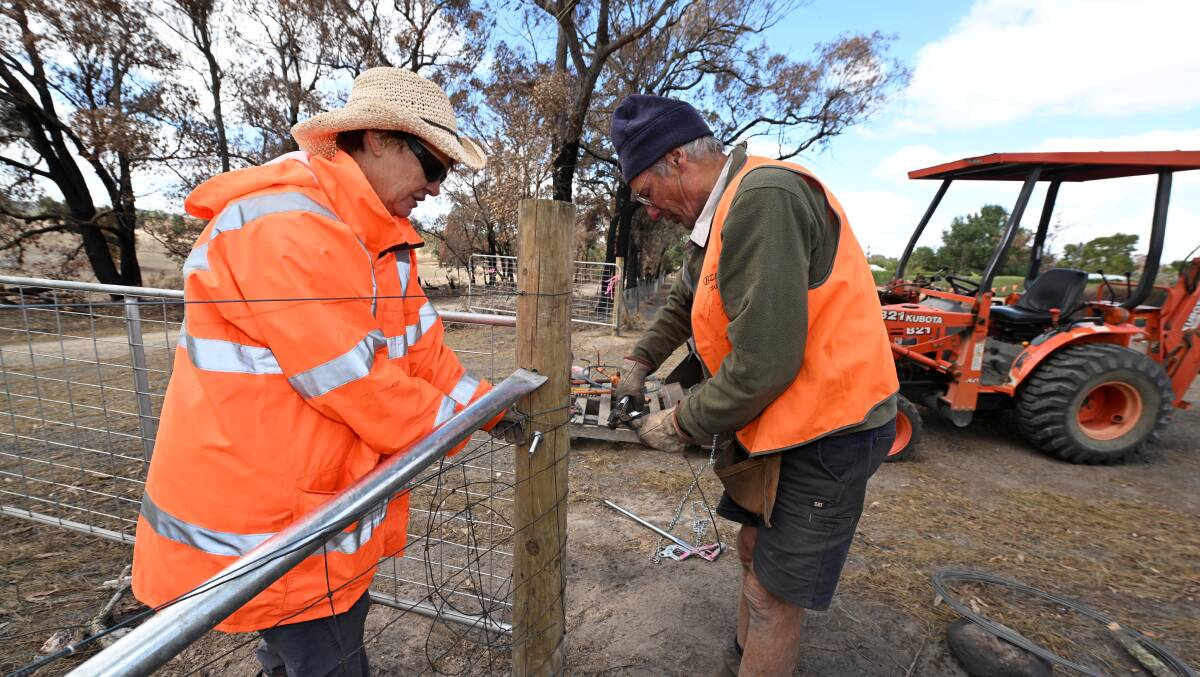 Blaze Aid volunteers Nikki Thompson and Mark Huntley help rebuild fences destroyed in the Mount Cole-Buangor blaze. Picture by Lachlan Bence
