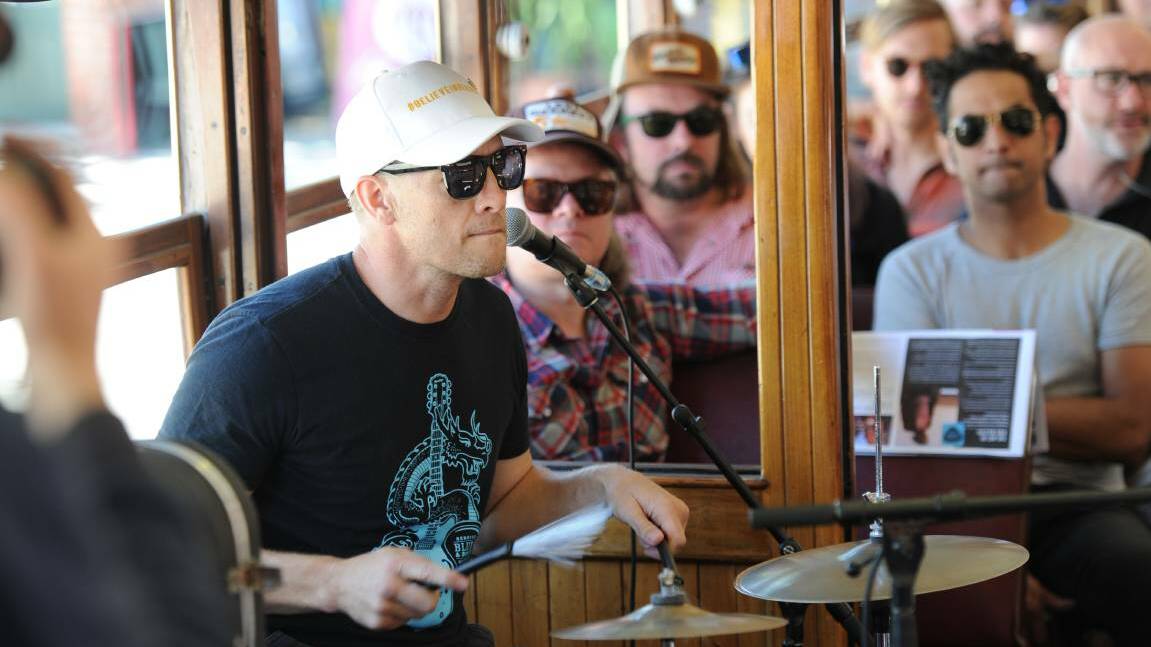 Colin Thompson plays on the Blues Tram.