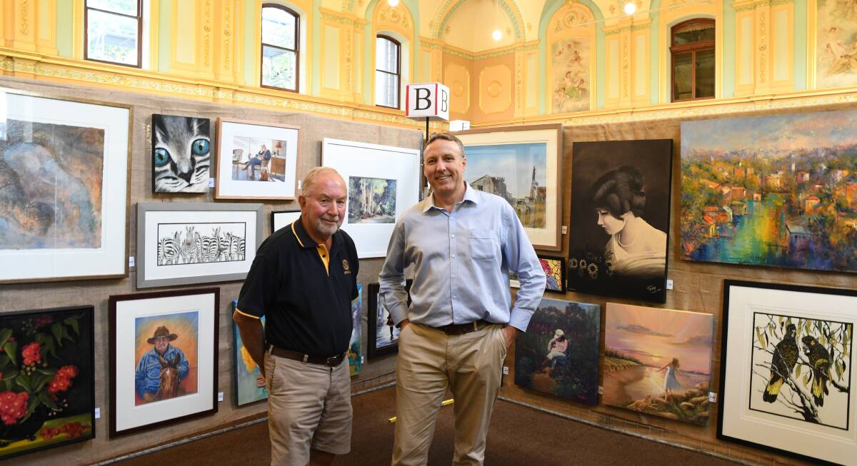 EXHIBIT: Bendigo Rotary Easter Art Show curator Des Samson and coordinator Brian Figg with the 2019 exhibits. Picture: CHRIS PEDLER.