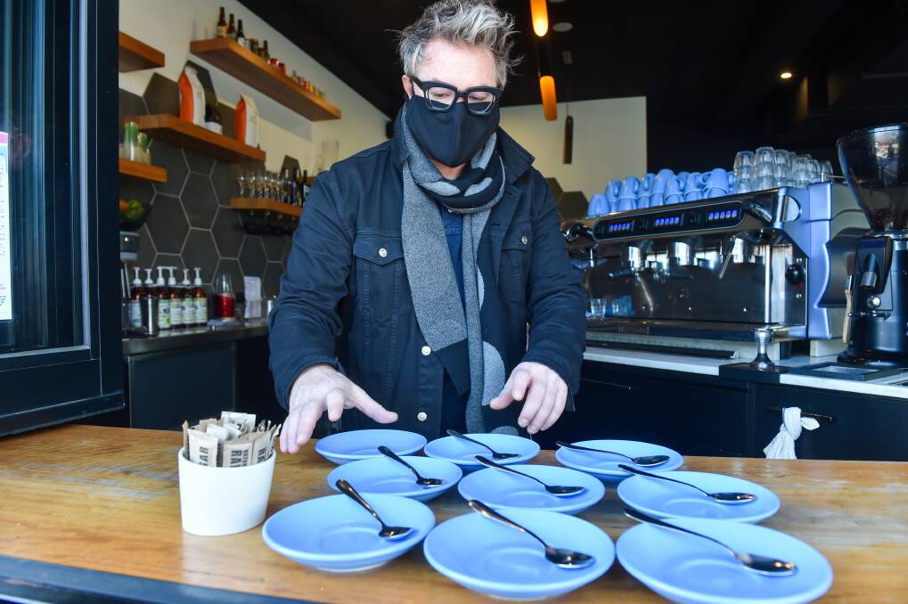 TABLE SERVICE: Tim Baxter is looking forward to welcoming customers back to Mollison Street's Ex Lion Tamer cafe, with coronavirus restrictions eased from Thursday. Picture: DARREN HOWE