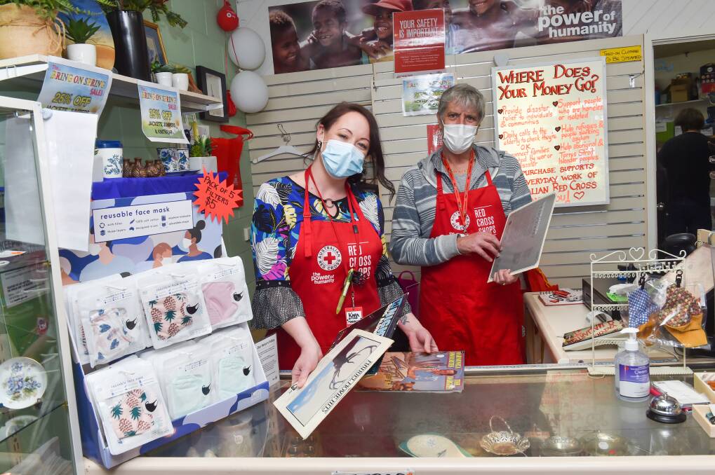 CHOICE: Australian Red Cross Shop Bendigo manager Kara Simmonds and volunteer Philip Rickard showing off some recent donations. Picture: DARREN HOWE