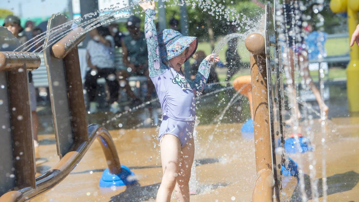 Alice Hart escapes the heat at the splash park. Picture: DARREN HOWE