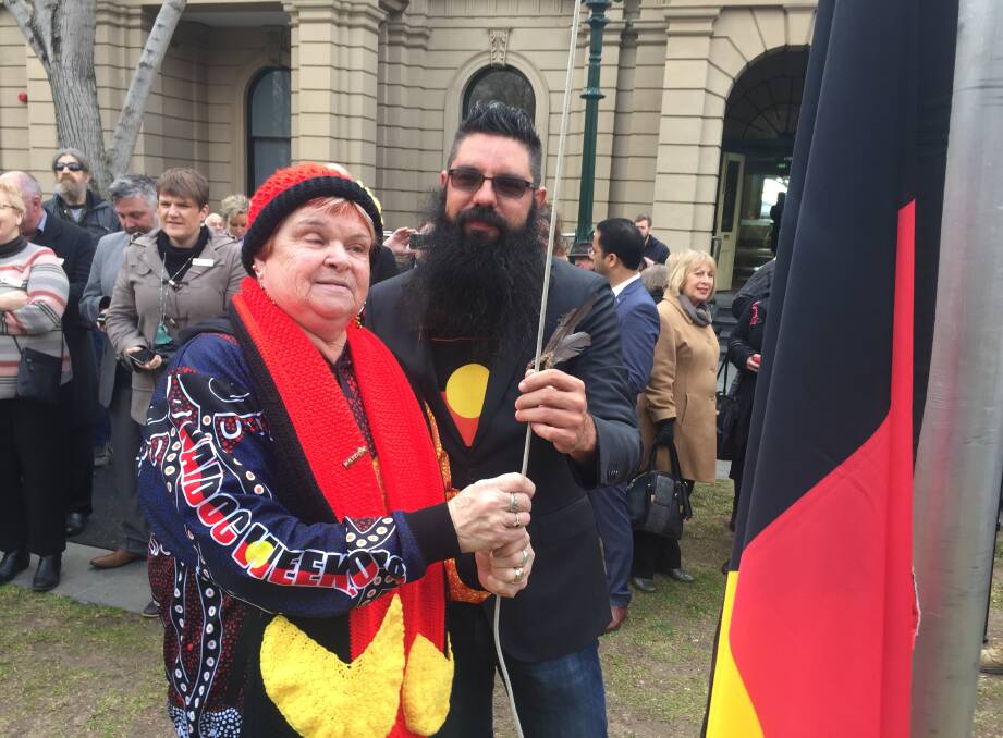 FLAG: Aunty Lyn Warren and Trent Nelson take part in the flag raising ceremony at the launch of NAIDOC Week in Bendigo. Picture: CHRIS PEDLER