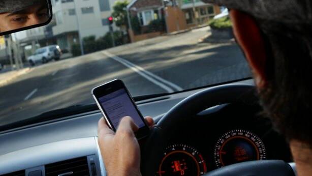 DANGEROUS: Half of people under 30 use phones when driving. Photo: KEN ROBERTSON