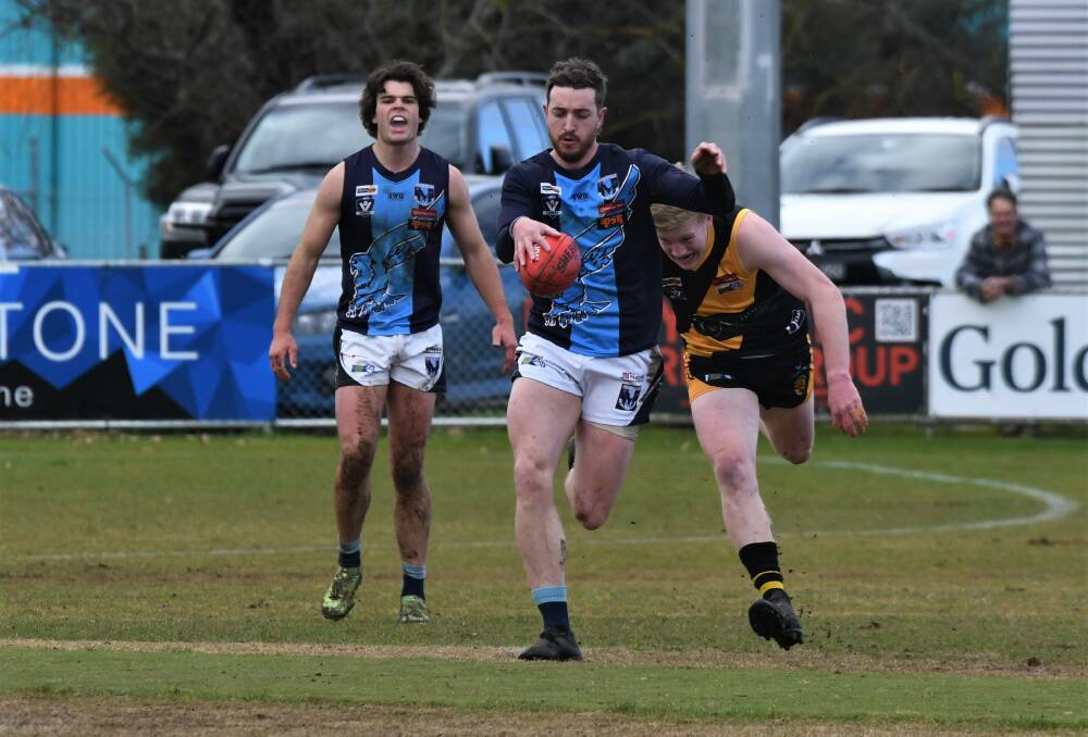 Eaglehawk's Clayton Holmes charges through the middle of the Kyneton Showgrounds.