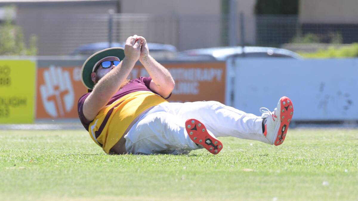 SAFE HANDS: Grassmere's Dan Boyle falls to the ground after taking a catch in division three action on Tuesday. Picture: NONI HYETT