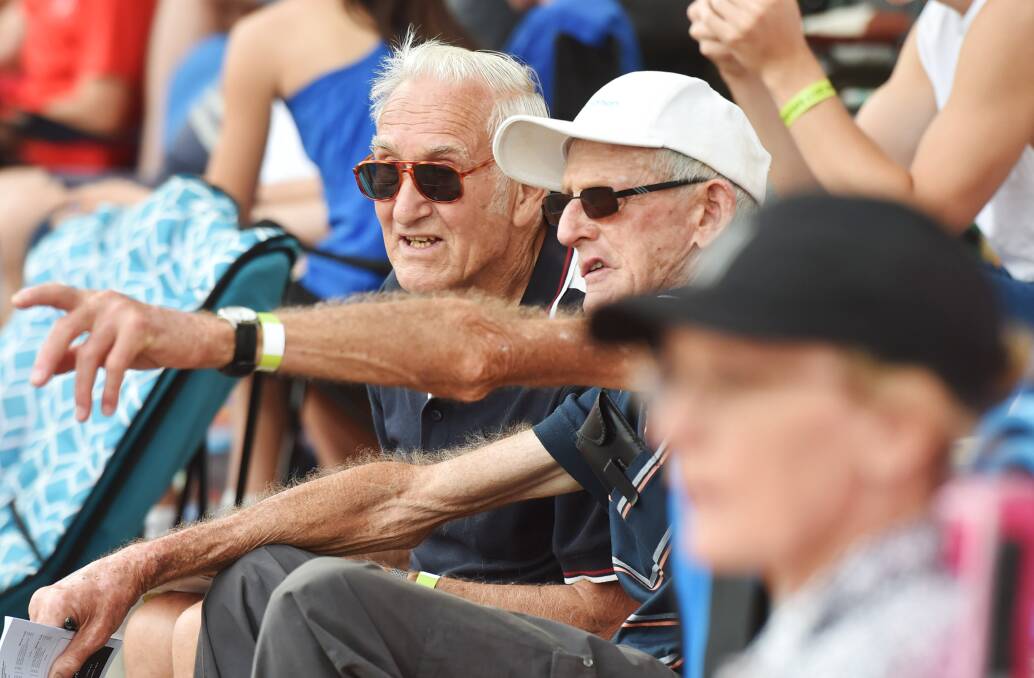 John Burke with his friend John Justice watching the athletics at the Bendigo International Madison carnival in 2017.