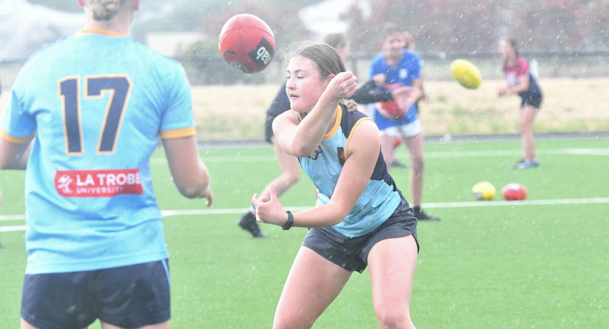 QUICK HANDS: Eve Cail fires out a handball at the Bendigo Pioneers' first pre-season training session on Sunday. Picture: ADAM BOURKE