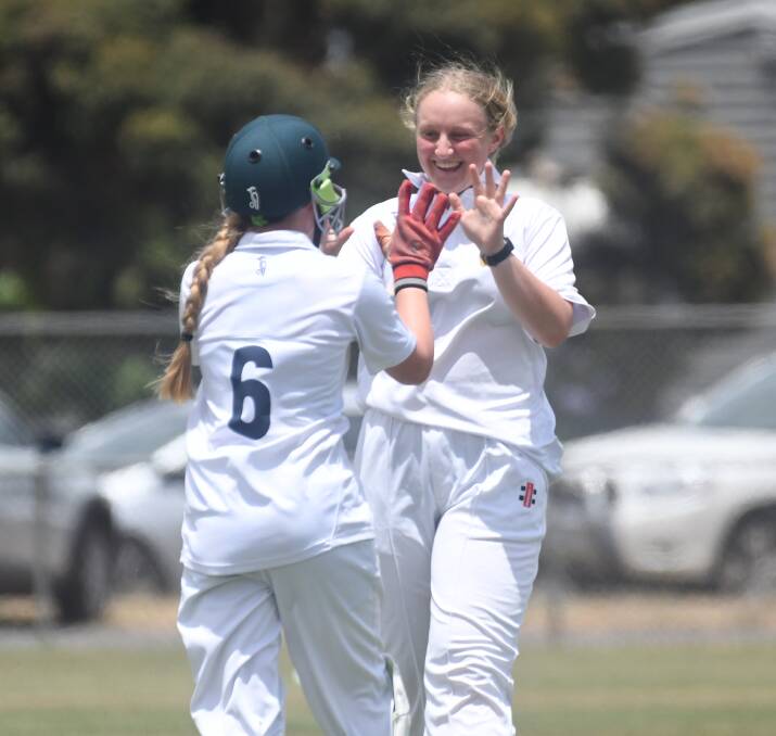 BDCA under-17 girls bowler Dannielle Flood and wicket-keeper Ruby Demeo celebrate after taking a wicket. Picture: ADAM BOURKE