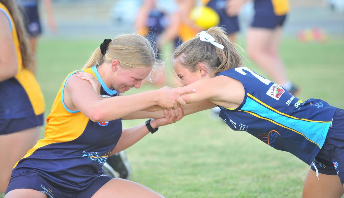 TEST OF STRENGTH: Pioneers' squad members Grace Sladden and Abbey Thompson at Epsom-Huntly Recreation Reserve. Picture: ADAM BOURKE