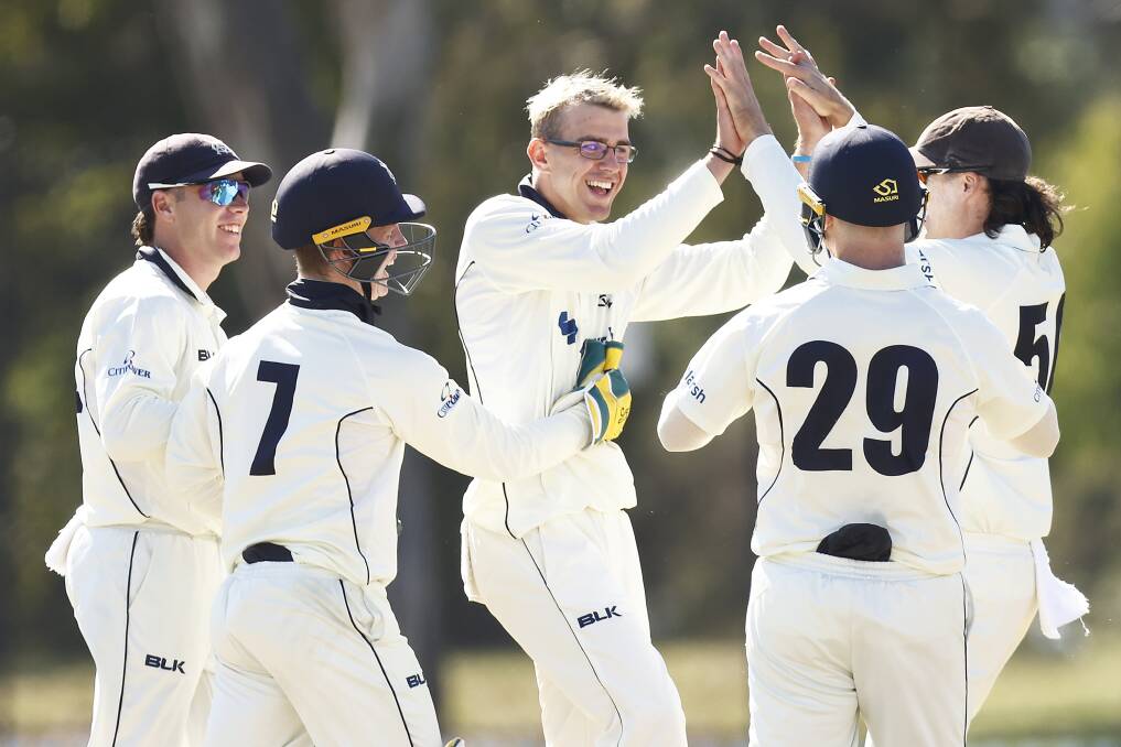 JUBILANT: Todd Murphy is mobbed by team-mates after claiming his first Sheffield Shield wicket on Saturday. Picture: GETTY IMAGES