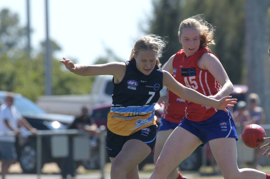 Pioneers' Grace Barton leads the race for the footy. Picture: NONI HYETT