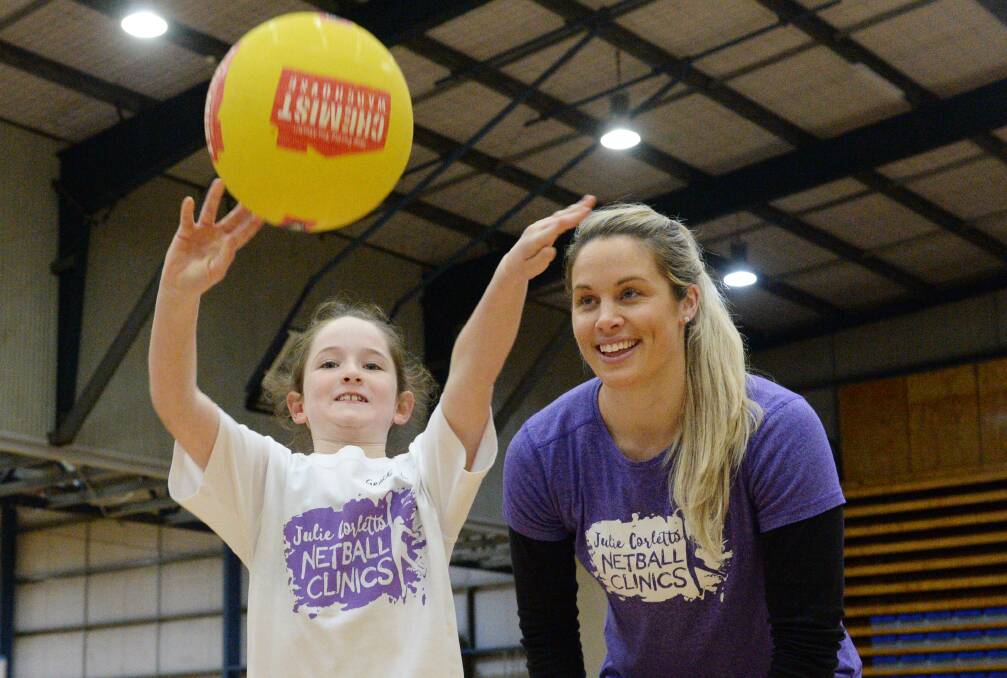 SKILLS SESSION: Former Diamonds star Julie Corletto with young netballer Grace Lamb at Bendigo Stadium on Tuesday. Pictures: DARREN HOWE