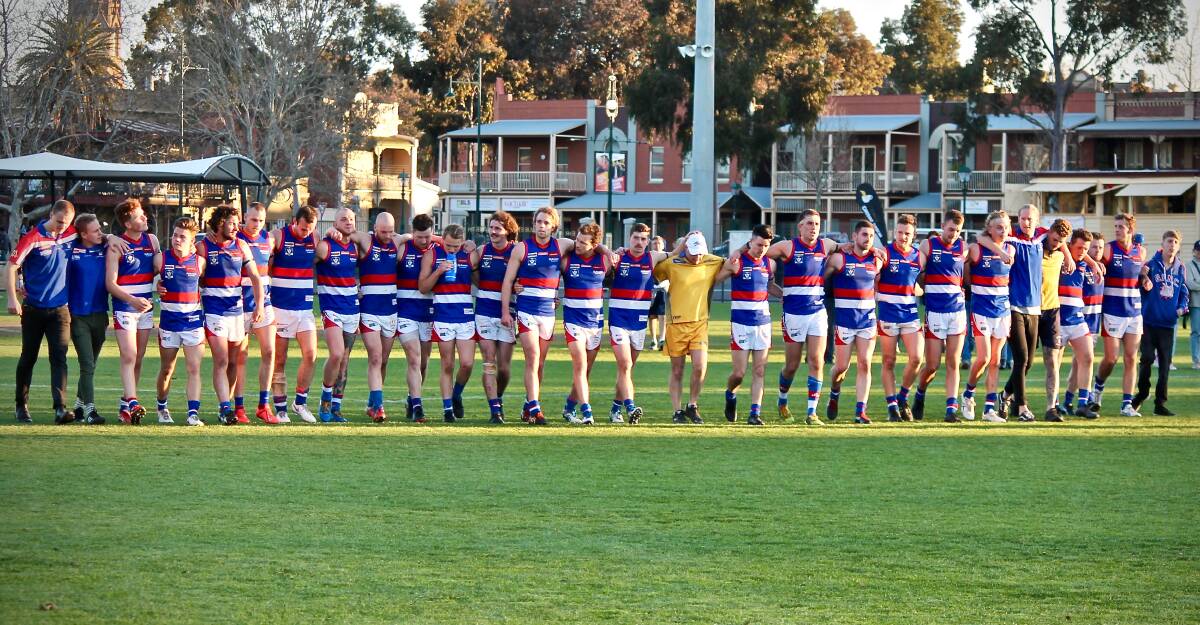 Gisborne players and coaching staff walk off the QEO as a united group to honour late team-mate Nathan Williams after the preliminary final loss to Eaglehawk. Picture: CONTRIBUTED