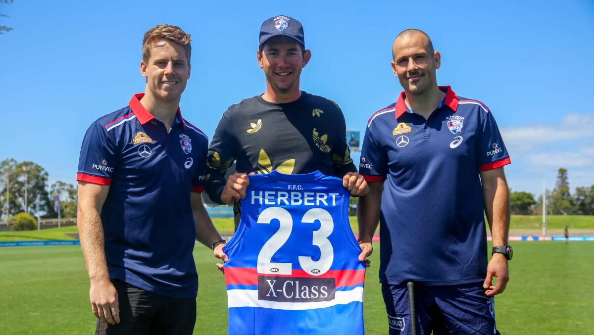 DOGS' FAN: Lucas Herbert with Lachie Hunter and Tory Dickson during a visit to the Whitten Oval in 2020. Picture: WESTERN BULLDOGS FC