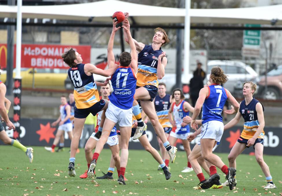 BIG THUMP: Pioneers' ruckman Aaron Gundry belts the ball clear of a stoppage against Gippsland on Sunday. Pictures: GLENN DANIELS