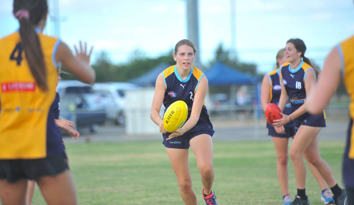 Maddy Marks fires out a handball.