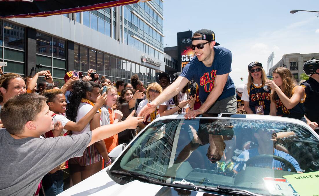 Matthew Dellavedova interacts with Cleveland fans at the Cavs NBA championship parade. Picture: GETTY IMAGES