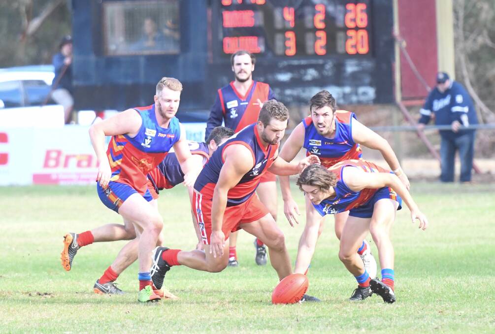 CONTESTED BALL: Calivil United coach Anthony Dennis puts pressure on Marong youngster Pat Gretgrix in their round one clash. Picture: ADAM BOURKE