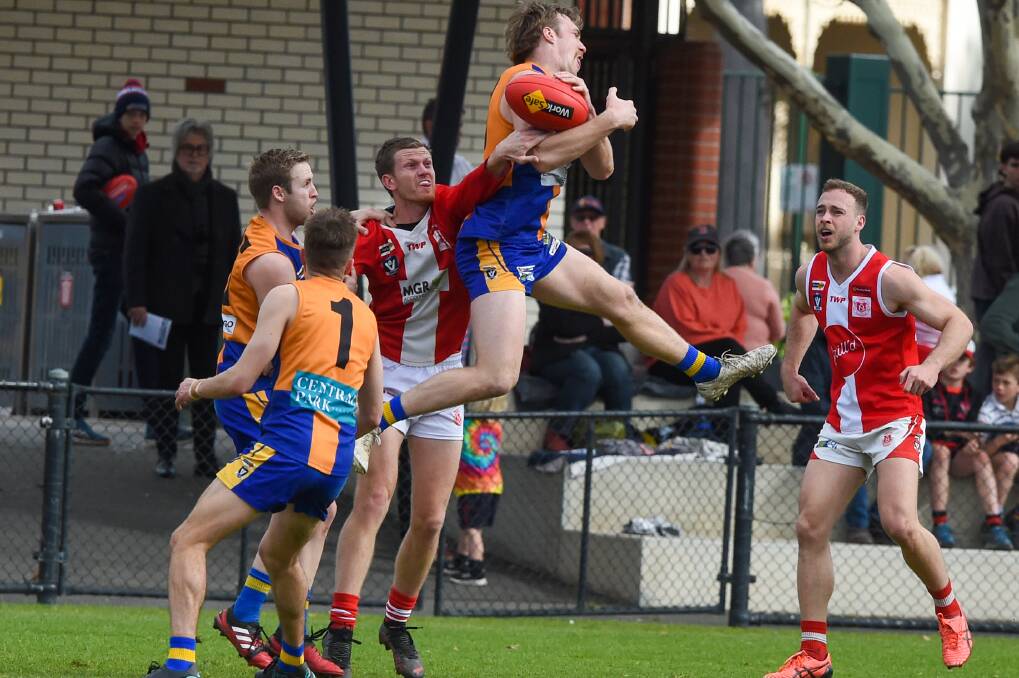 Golden Square's Jayden Burke flies high in a bid to take a mark against the Bloods. Picture by Darren Howe