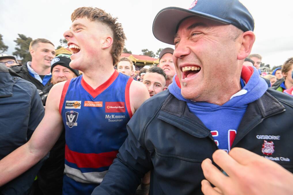 Rob Waters and Liam Spear in the middle of Gisborne's premiership celebrations. Picture by Darren Howe