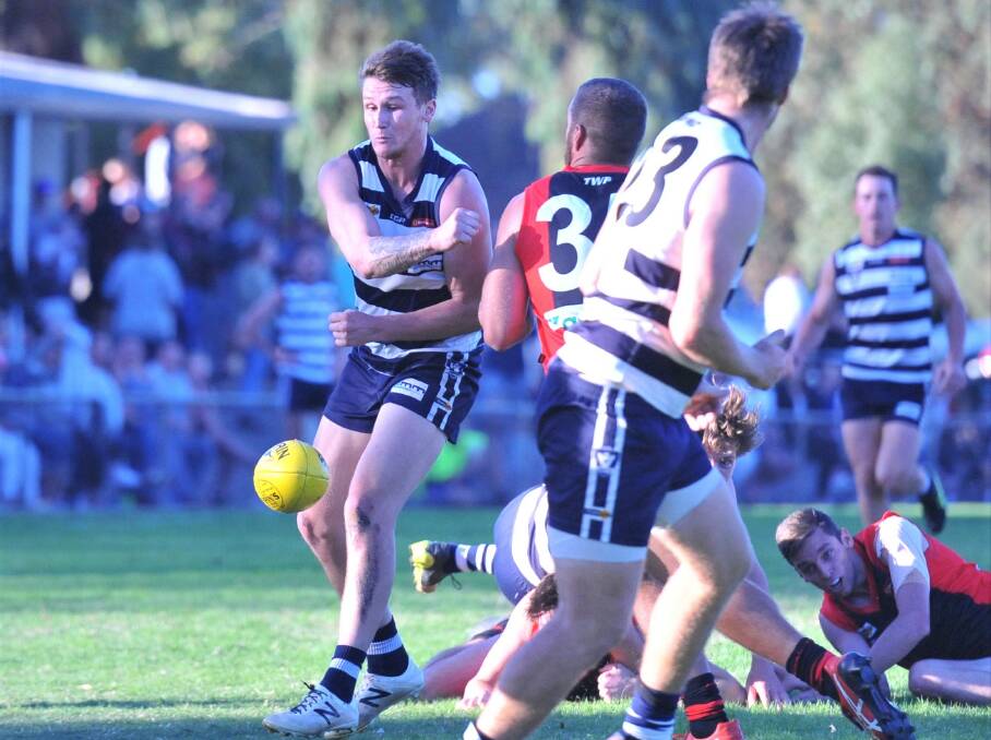 Zeik Johnston fires out a handball for the LBU Cats. Picture: ADAM BOURKE