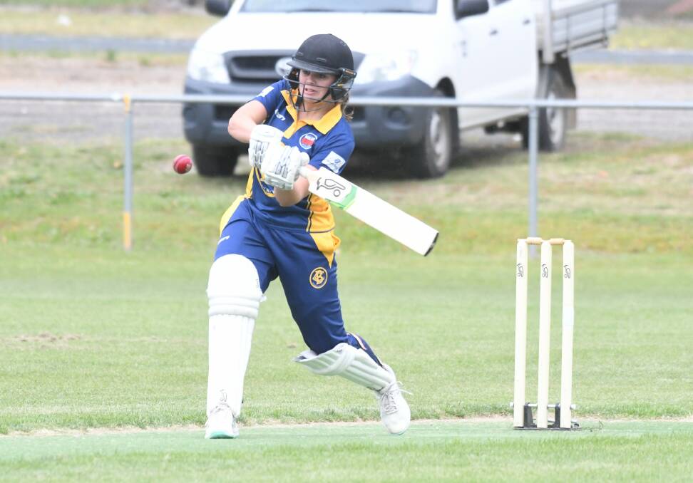 GREAT KNOCK: Bendigo's Amy Ryan belts one of her six boundaries in her innings of 52 on Sunday. Picture: ADAM BOURKE