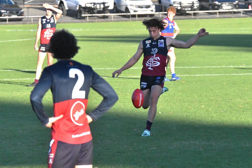 Ollie Hannaford kicks the goal that sealed victory for Sandhurst. Picture by Adam Bourke