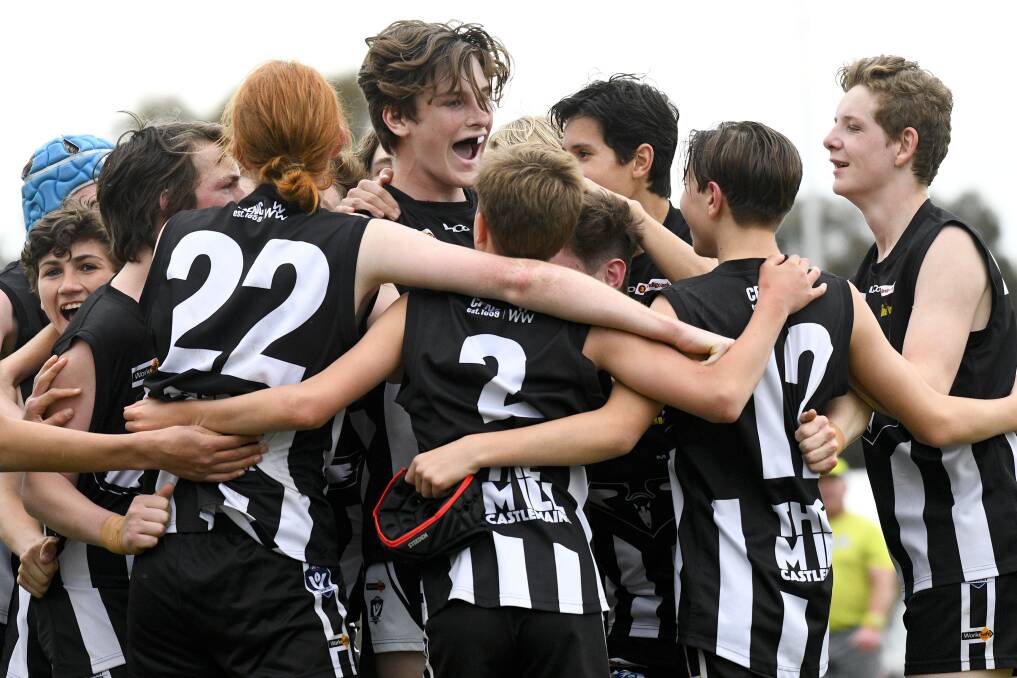 Castlemaine players celebrate their grand final win over Eaglehawk. Picture: NONI HYETT