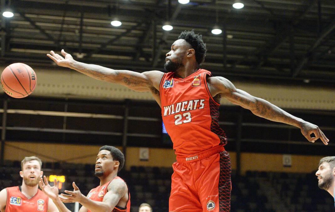STRETCH: Terrico White chases a rebound for the Perth Wildcats against the New Zealand Breakers.