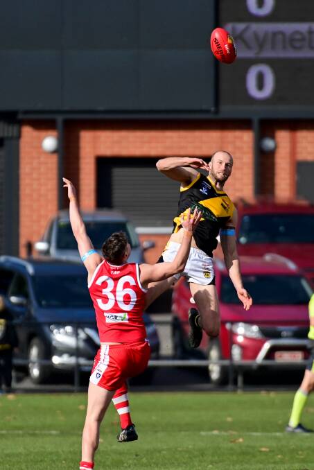 GOLDEN FIST: Kyneton ruckman James Orr punches the ball clear. Picture: BRENDAN McCARTHY