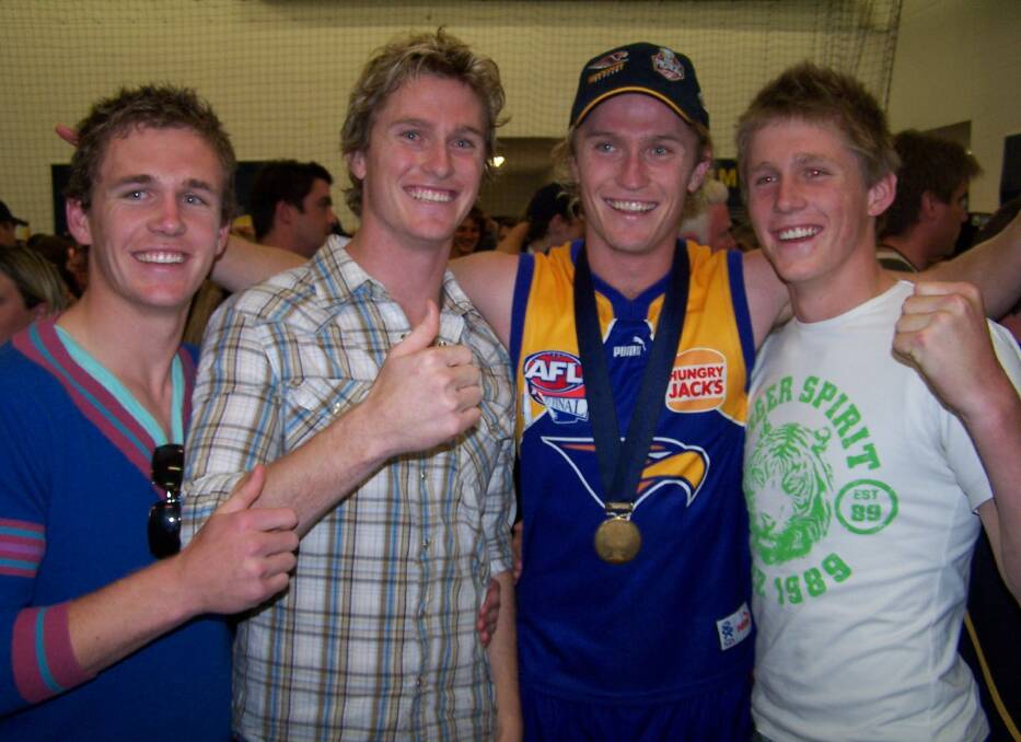 The brothers celebrate Adam's grand final success with West Coast in 2006.
