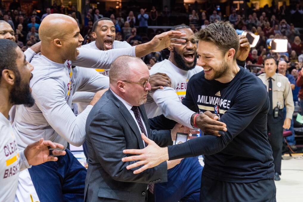 Matthew Dellavedova is swamped by LeBron James and the Cleveland Cavaliers at his NBA Championship ring presentation. Picture: GETTY IMAGES