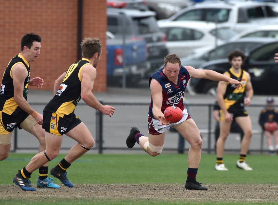HARD TO STOP: Sandhurst skipper Blair Holmes runs on to a loose ball against the Tigers.