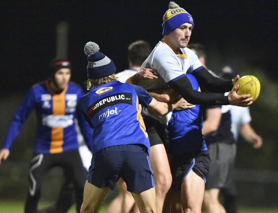 CRUNCH: Golden Square defender Will Lee rides a tackle at training on Thursday night. Picture: NONI HYETT