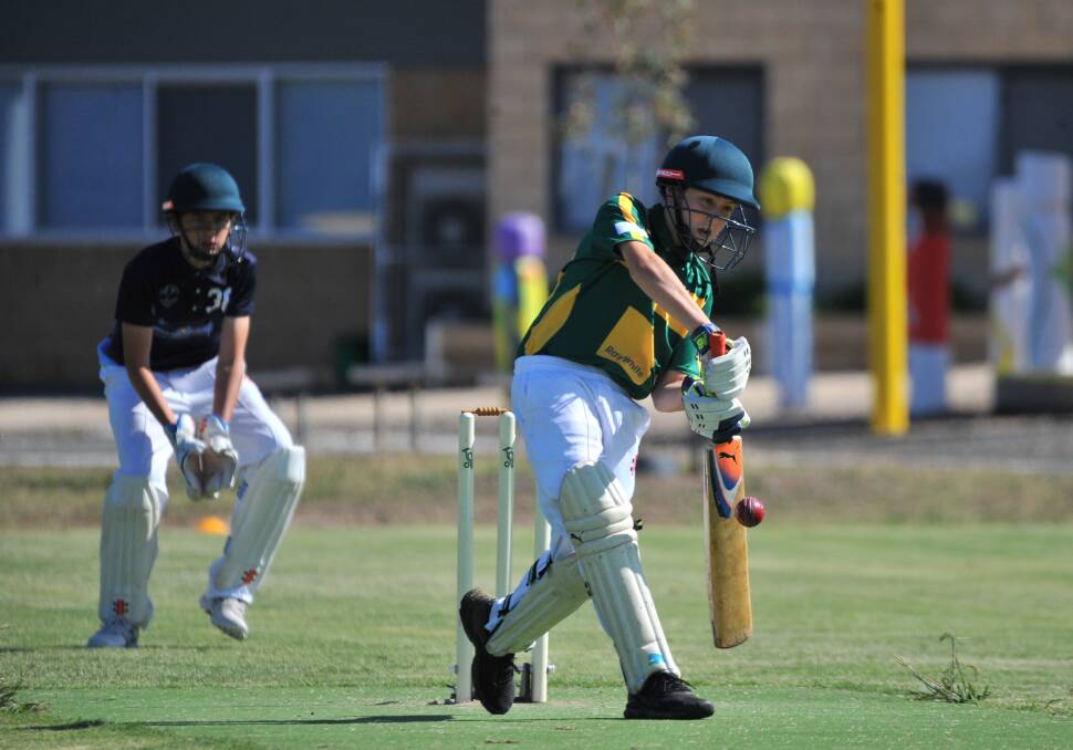 BOUNDARY: Kangaroo Flat under-12A batsman Clay Smith plays a beautiful cover drive in Sunday's game against Eaglehawk. Pictures: ADAM BOURKE