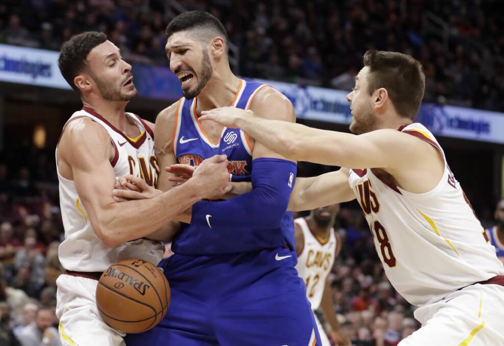 TENACIOUS: Matthew Dellavedova, right, tries to strip the ball from New York Knicks centre Enes Kanter in the Cavs' 113-106 win. Picture: AP