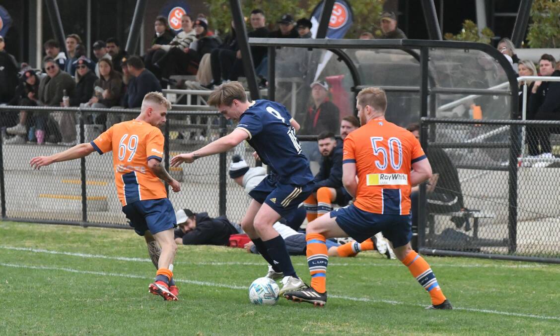 Bendigo City striker Ethan Hunter takes on two Lara United defenders in Saturday's 4-1 loss at Epsom-Huntly Recreation Reserve. Picture by Adam Bourke